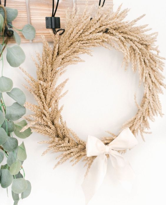 A wheat wreath with a white bow. 